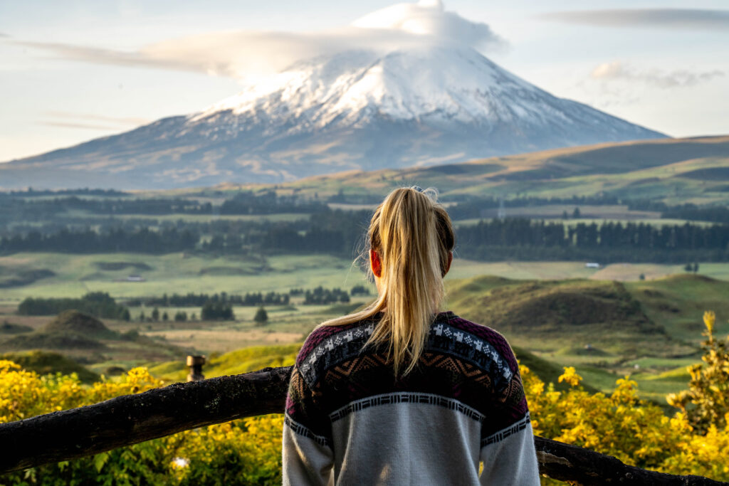 woman observing the cotopaxi volcano from Secret Garden Hotel